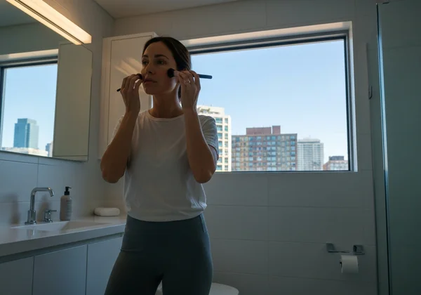 Person hiding true self behind a facade in social setting